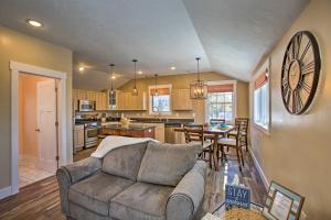 a living room with a couch and a kitchen at Cozy Urban Ludington Apt about 1 Mi to Lake Michigan in Ludington