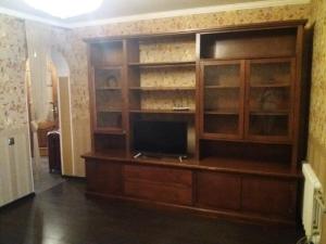 a entertainment center with a television in a room at Аркадия Флэт in Odesa