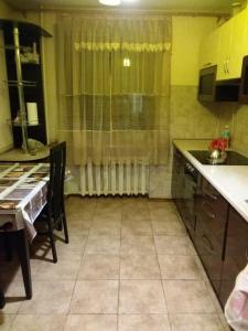 a kitchen with a table and a sink and a table and a kitchen with at Аркадия Флэт in Odesa +9 photos