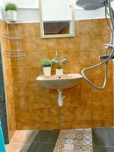 a bathroom with a sink and a mirror at Апартамент Компас in Burgas City +22 photos