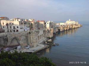 a group of buildings on the side of a river at VILLETTE FABRIZIO, 2023 a VIESTE in Vieste