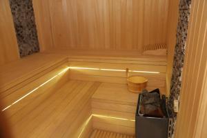 an inside of a sauna with a bucket in it at Luxe Lankaran Hotel in Lankaran