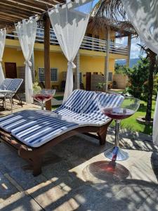 a bed sitting on a patio with a table at Pousada do Irlandês in Pirenópolis