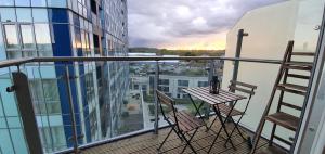 a balcony with two chairs and a table on a building at The Glassworks by Ritual Stays in Hemel Hempstead