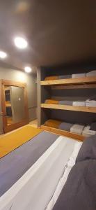 a bedroom with two bunk beds and a mirror at Bucanaan hostel boutique in Cordoba