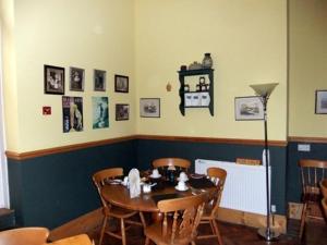 a dining room with a table and chairs at College Guest House in Haverfordwest