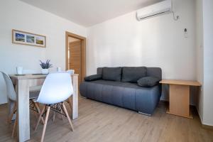 a living room with a couch and a table at Apartmani Frane in Neum +9 photos