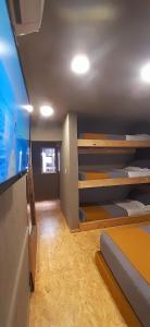 a room with bunk beds and a flat screen tv at Bucanaan hostel boutique in Córdoba