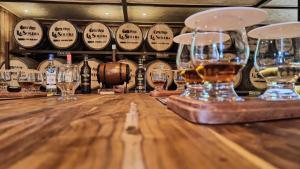 a bar with wine glasses on a wooden table at TREE TREK BOQUETE Adventure Park in Boquete