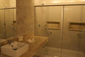 a bathroom with a sink and a glass shower at Holiday Inn - Goiania, an IHG Hotel in Goiânia