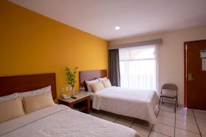 Postel nebo postele na pokoji v ubytování Hotel Arcos Aeropuerto