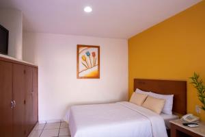 Postel nebo postele na pokoji v ubytování Hotel Arcos Aeropuerto