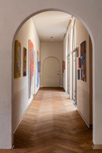 an arched hallway with paintings on the walls at Tá Hotel de diseño in Querétaro