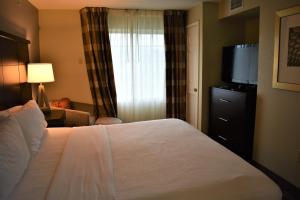 pokój hotelowy z łóżkiem i telewizorem w obiekcie Staybridge Suites Cranbury - South Brunswick, an IHG Hotel w mieście Cranbury