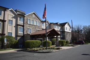 CranburyにあるStaybridge Suites Cranbury - South Brunswick, an IHG Hotelの前面にアメリカ旗を掲げた建物