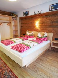 a bedroom with two beds with red and white pillows at Ferienwohnung Brugger in Zellberg