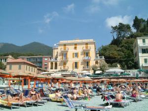 a group of people sitting in chairs on a beach at Hotel La Spiaggia in Monterosso al Mare