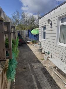 a backyard with a house and a table and chairs at Peaceful Garden Apartment in Herne Bay