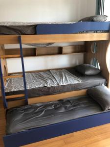 two bunk beds in a dorm room with at Eden Island Apartment with a View in Sidi el Haj Bou Derbala