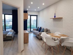 a living room with a couch and a table and chairs at Sunrise Arcadia Sky in Odesa +97 photos