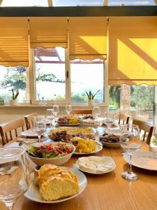 a table with plates of food and glasses of wine at Promachon Villa in Foinikiá