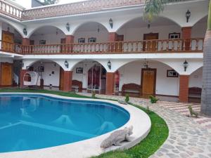 a house with a swimming pool in front of it at Hotel Leyenda del Tepozteco in Tepoztlán