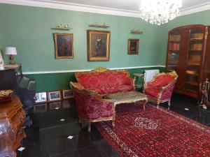 a living room with a couch and two chairs at Chateau Gunes (Guges) in Cissac-Médoc