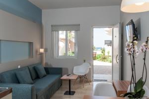 a living room with a couch and a table at Corinna Mare in Kalamaki