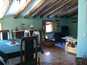 a living room with a table and chairs in a house at Casa Rural Torre De Campos in Ainzón