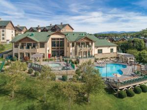 an aerial view of a large house with a swimming pool at Club Wyndham Smoky Mountains in Pigeon Forge