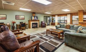a living room with leather furniture and a fireplace at Club Wyndham Tamarack in Wisconsin Dells