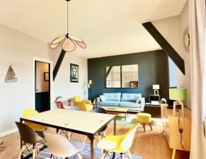 a living room with a table and chairs at Fontaines de Morny in Deauville