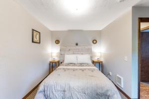 a bedroom with a bed and two night stands at Sweet Netarts in Tillamook