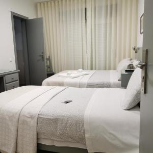 
A bed or beds in a room at Flor da Primavera - Residencial e Apartamentos
