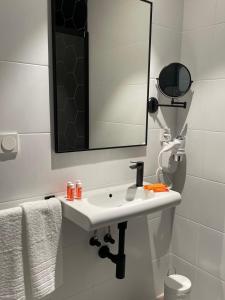 y baño con lavabo blanco y espejo. en LC Hotel Urbano, en Alicante