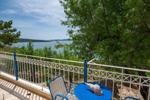 a pair of chairs and a teddy bear sitting on a balcony at SEA VIEW RETREAT STUDIO IN AGIOS KONSTANTINOS! in Dhavgáta