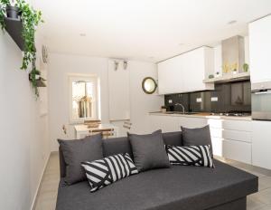 a living room with a couch and a kitchen at Lucy's House in Riomaggiore