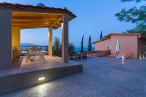 a pavilion with a picnic table on a patio at ELIA VILLA 1 in Alikanas