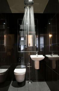 a bathroom with a toilet and a sink and a mirror at East Walls Hotel in Chichester