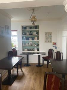 a dining room with a table and chairs at Racecourse View in Listowel