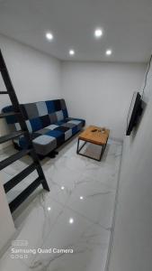 a living room with a couch and a coffee table at Studio Apartman Malkoc in Bihać
