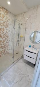 een badkamer met een douche en een wastafel bij M&P VIP Appartments in Arkadia in Odessa