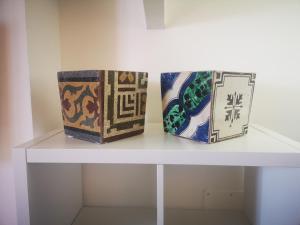 two boxes are sitting on a white shelf at Skylight Sorrento in Sant'Agnello