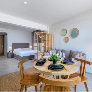 salon ze stołem i łóżkiem w obiekcie NOA BEACHFRONT SUITES w Kardamenie