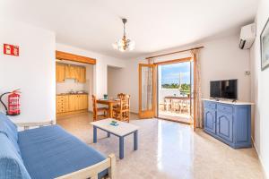 a living room with a blue couch and a table at Apartamentos Karin 1ºB in Felanitx