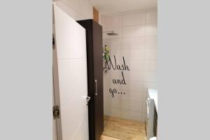 a bathroom with a door with a sign on the wall at Urlaub machen wo andere arbeiten :) in Klagenfurt
