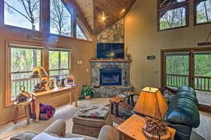 a living room with a couch and a fireplace at Spacious Maggie Valley Cabin with Hot Tub and MTN View in Maggie Valley
