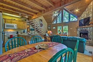 a kitchen and dining room with a table and chairs at Spacious Maggie Valley Cabin with Hot Tub and MTN View in Maggie Valley