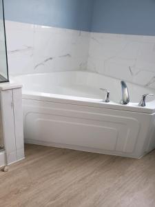 a white bath tub in a bathroom with marble walls at salish Inn in Anacortes