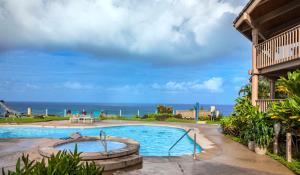 a swimming pool with the ocean in the background at Club Wyndham Shearwater in Princeville